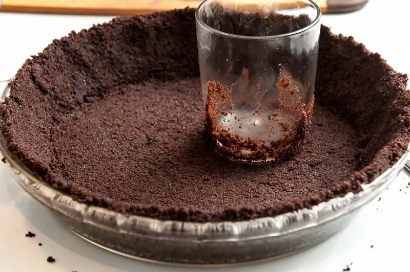 The chocolate wafers pressed firmly into the pie plate.