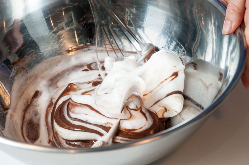 Folding the meringue and chocolate custard.