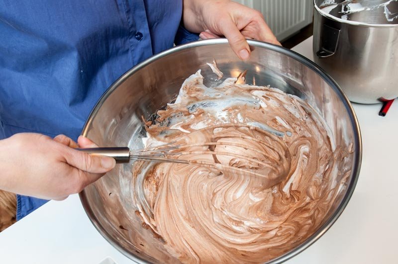 The whipped cream being added to the chocolate and meringue. Becoming Bavarian Cream.