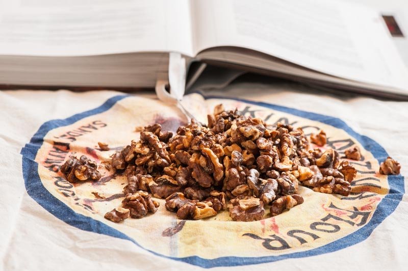 Taking the skins off the toasted walnuts.