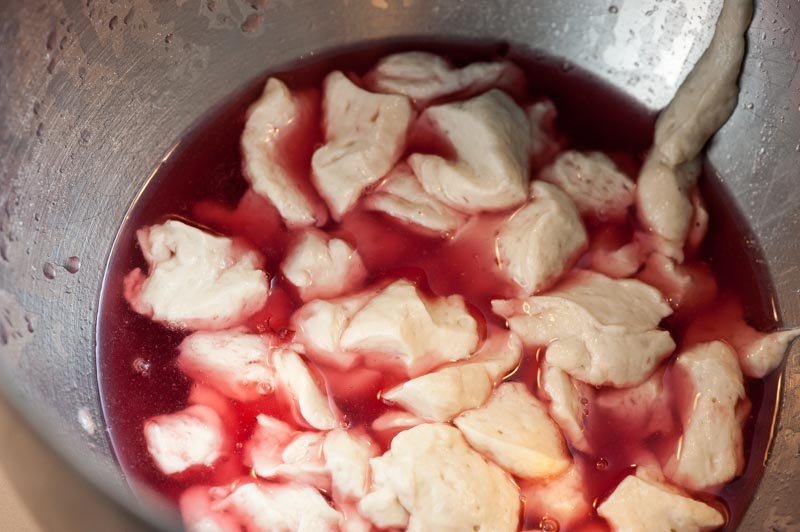 Dropping the biga into the cranberry liquid.