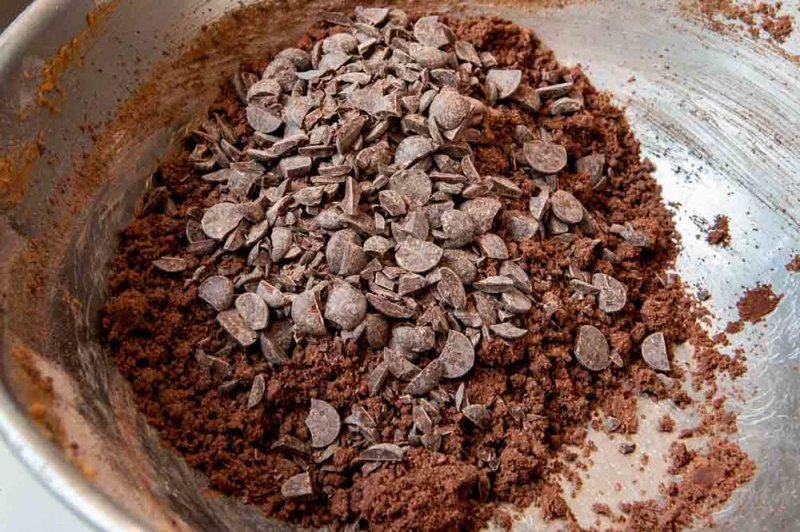 Adding chopped chocolate to the cookie dough.