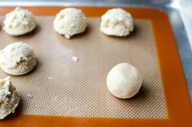 Shape the cookie dough into balls before pressing.