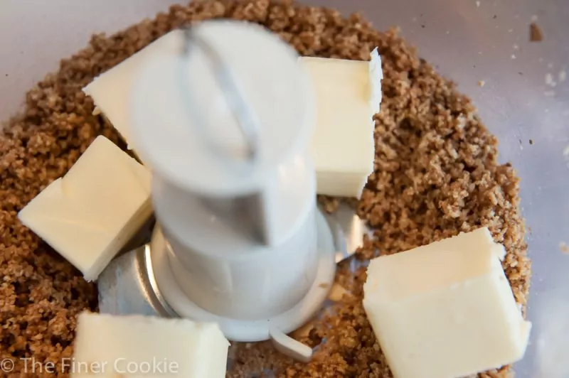 Adding butter to the nut and sugar mixture.