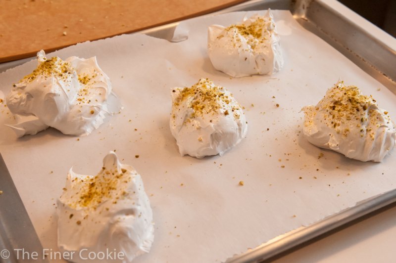 Spoonfuls of pistachio rose water meringue ready to dry in the oven.