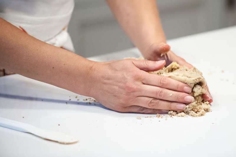 Gathering the dough to hold together.