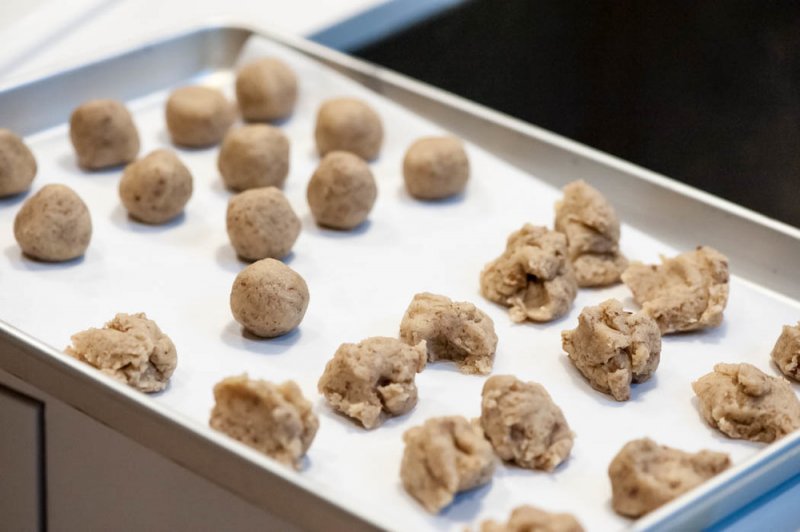 Rolling the dough into 1 inch balls.