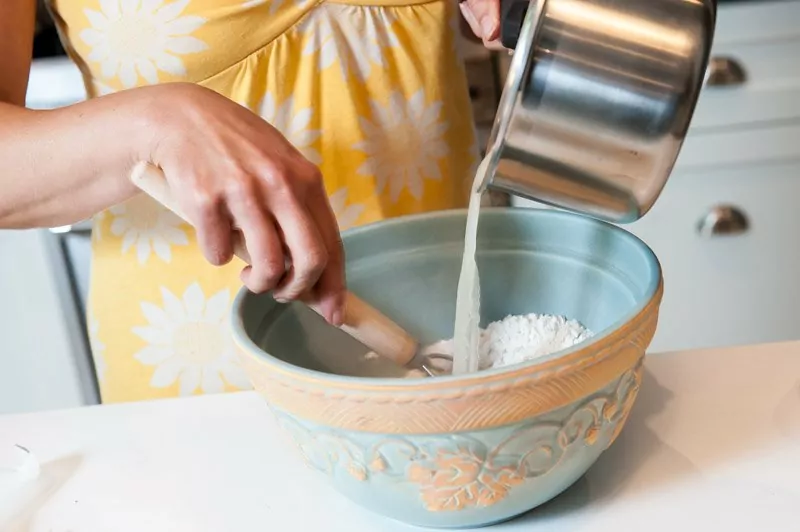 Add hot liquids into the dry ingredients.