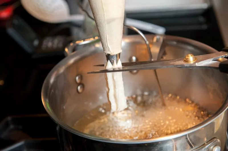 Press out the churro batter and cut the dough to the desired length.