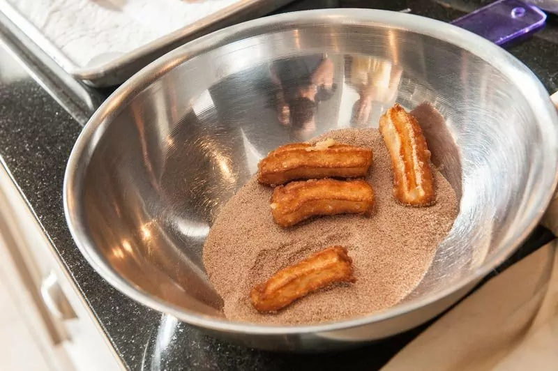 The churros in the cinnamon and sugar.