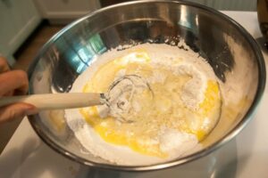 Blending the wet ingredients into the dry with the dough whisk.