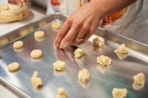 Measuring and shaping the minis on the tray.