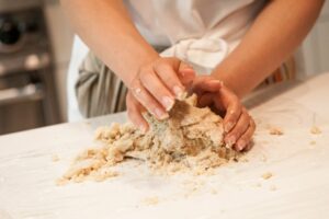 Kneading the dough together.