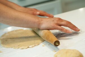 Rolling the dough between two pieces of plastic.