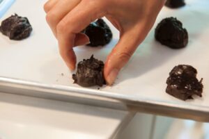 Setting the cookie dough on the tray.