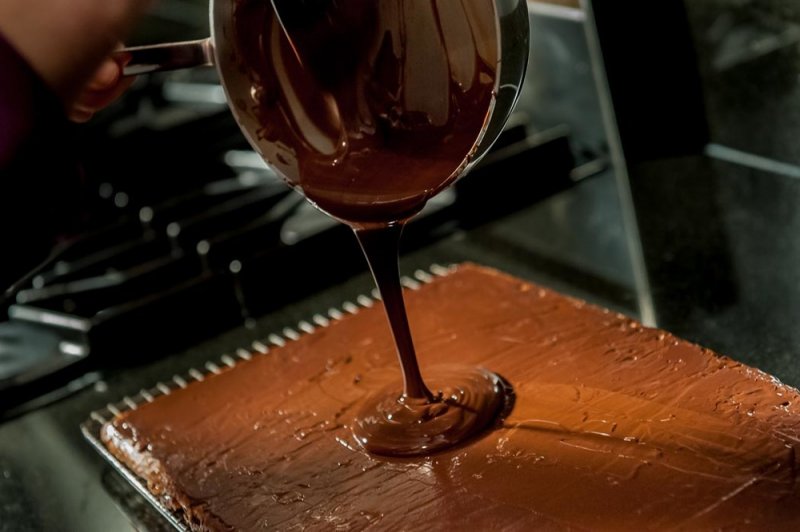 Pouring the second coat of chocolate.