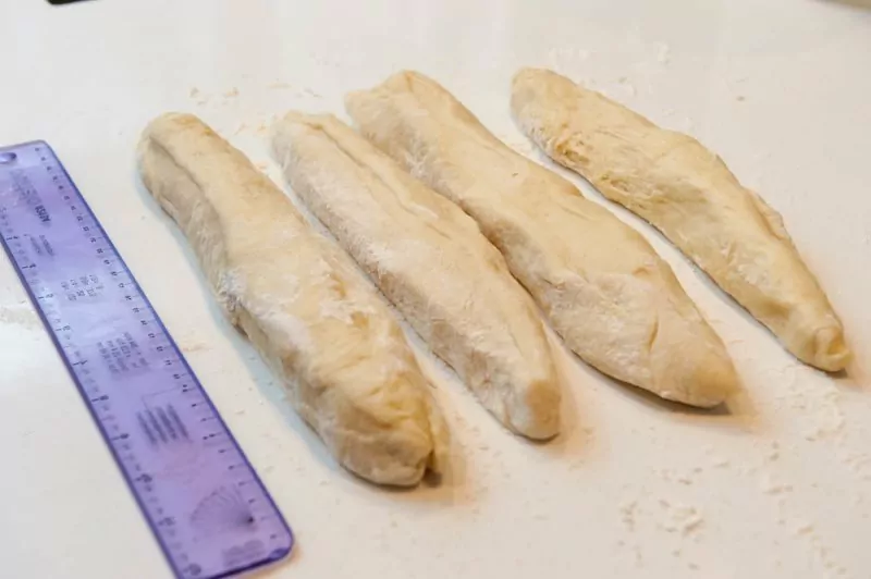 Shaping the Challah to make a 4-braid loaf. The strands at 9 inches.