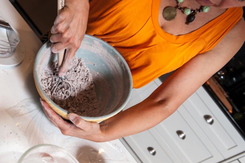 Mixing the egg into the flour and butter.