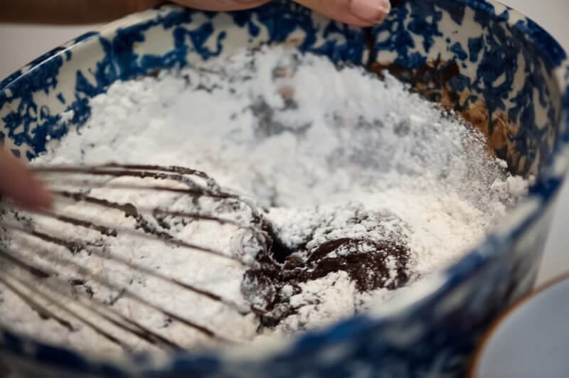 Adding the flour to the batter.