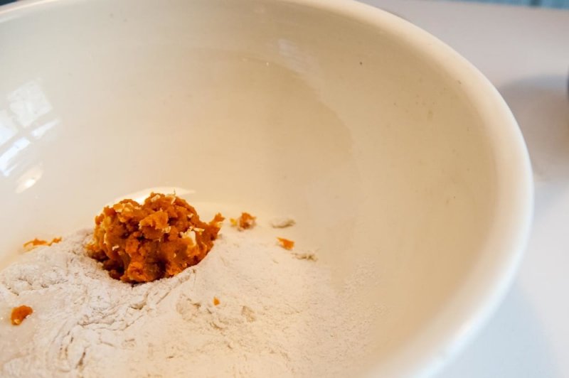 The sweet potato and butter going into the dough starter and flour mix.