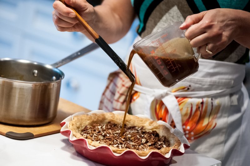 Pouring the filling over the pecans.