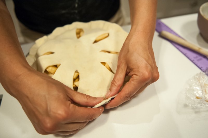 Sealing the top pastry with the bottom pastry.