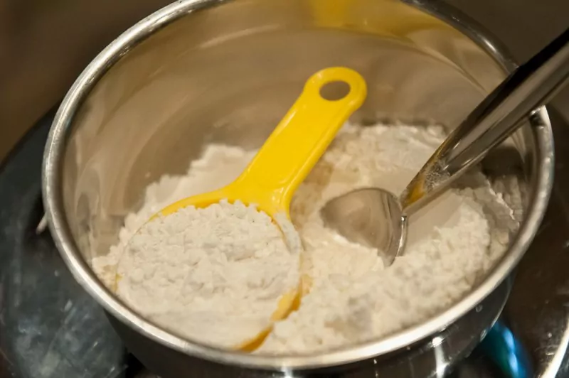 The dry ingredients with a half cup of the flour set aside