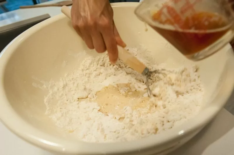 Adding the beer to the dry ingredients.