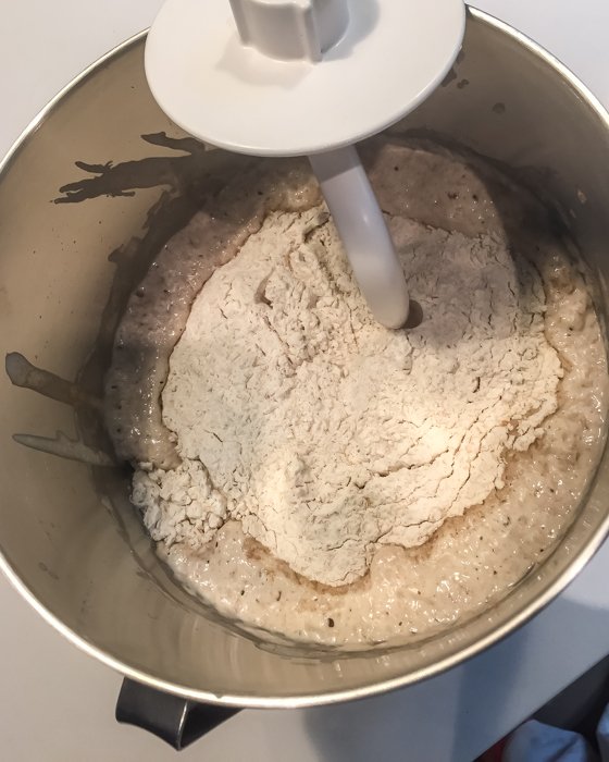 Adding the flour to the bubbly starter.