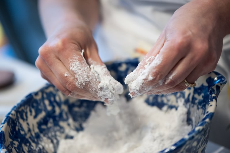 Pinching the shortening into the flour.