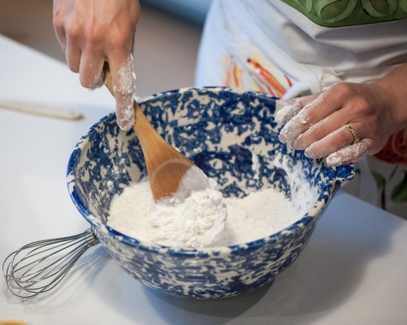 Stirring the flour and buttermilk into the flour.