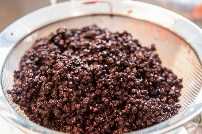 The elderberries draining. At this point, they appear plump and soft.