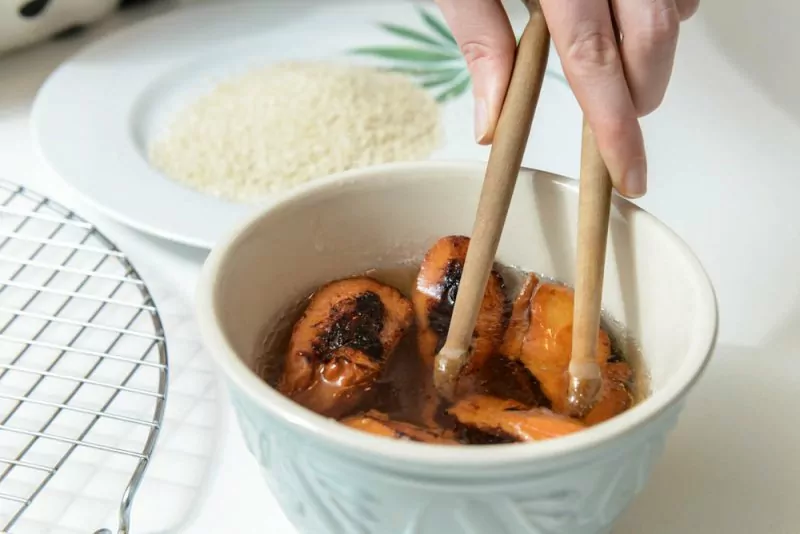 Dipping the fried Makroud in the Orange Blossom Sugar Syrup.