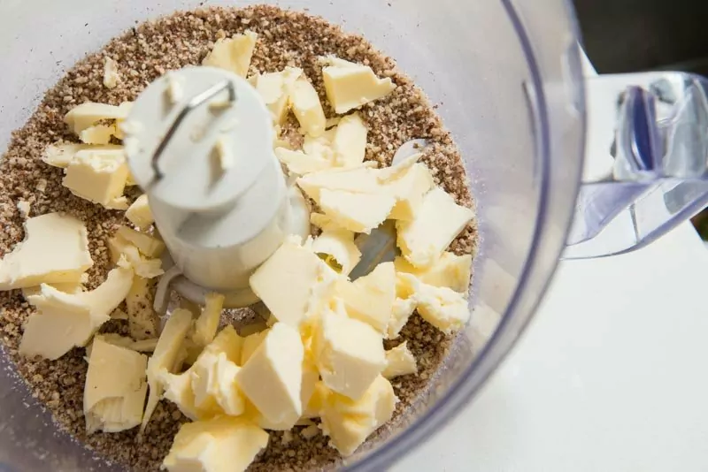 Add the cold butter into the finely ground pecans and sugar.