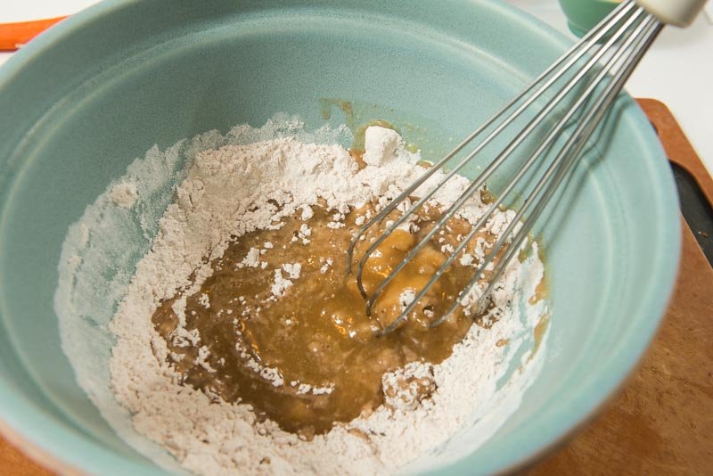 Whisk the melted butter and sugar into the dry ingredients.