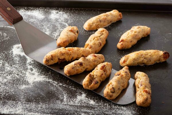 Cornmeal Apricot Fingers placed on spatula on top of table