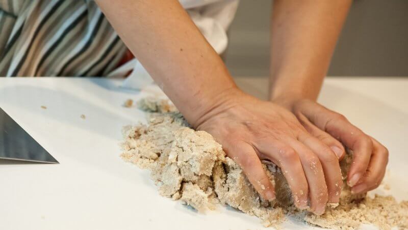 Kneading the cookie dough into shape.