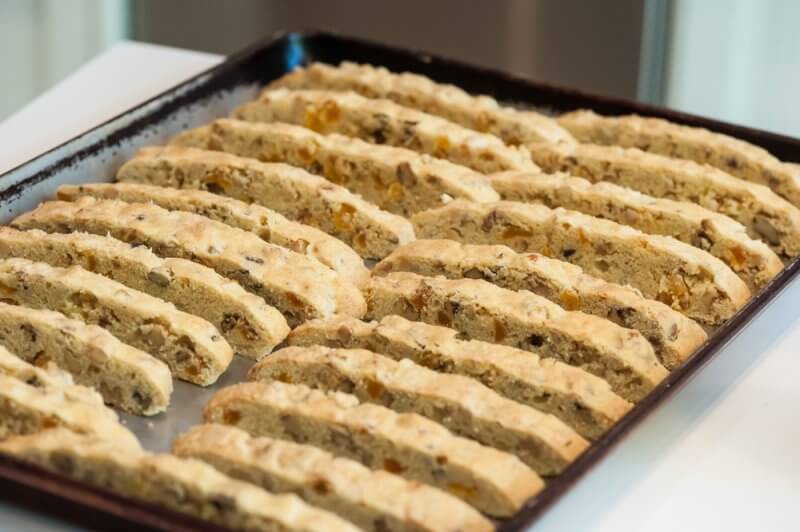 Freshly cut biscotti standing on a tray.
