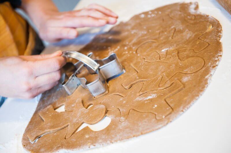 Cutting the shapes of the gingerbread men.