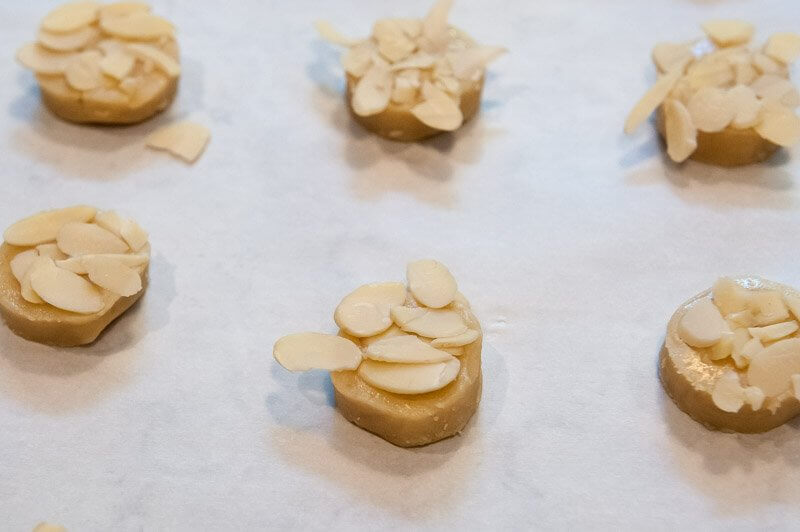 A tray of cookies coated with sliced almonds.