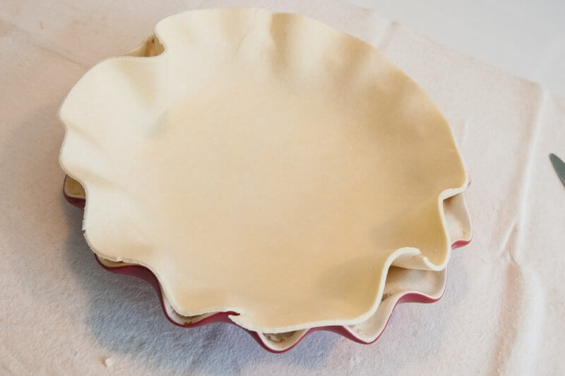 Laying the bottom pastry in the plate.