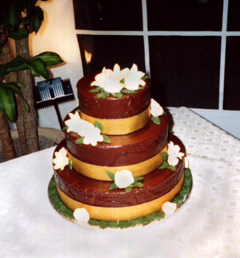 A snapshot of a chocolate wedding cake I made from The Cake Bible. Rick snapped this pic just before we left the hall. I made the flowers and the green leaves and everything. Looking back on it now, it was so much work! Circa 2000.