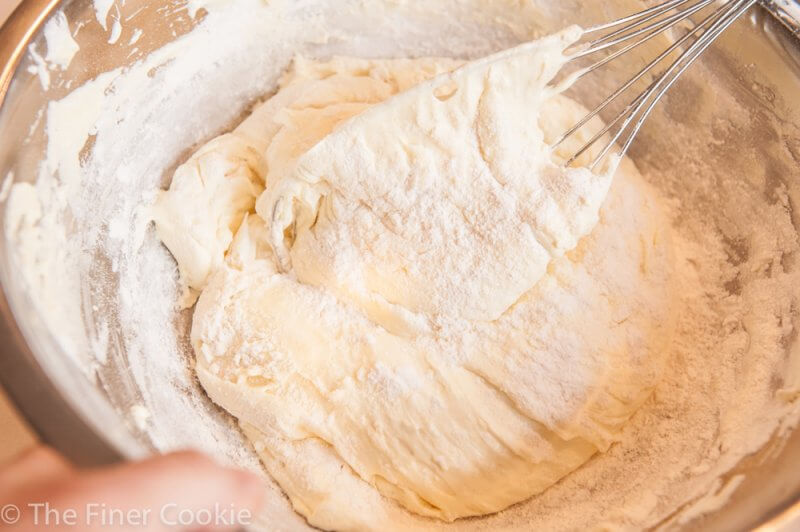 Folding the flour into the eggs and sugar