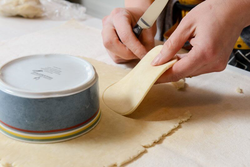 Cutting the pastry for the tins.