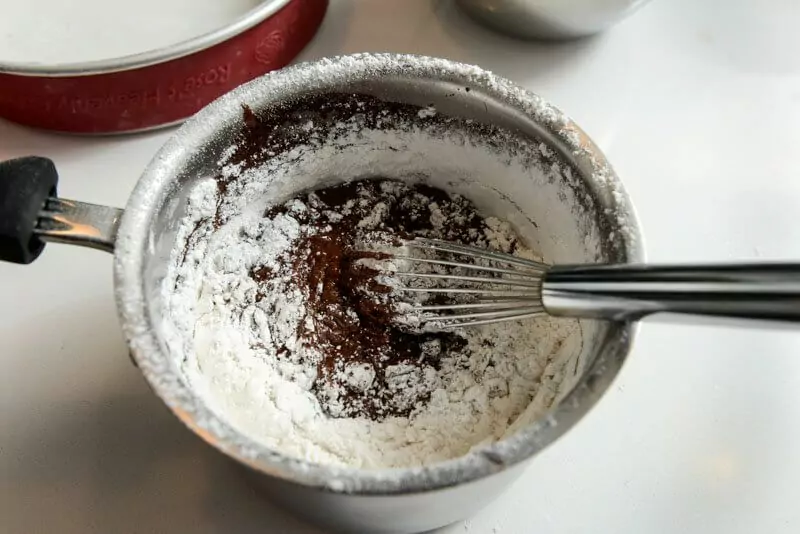 Folding in the flour to the cooked chocolate.