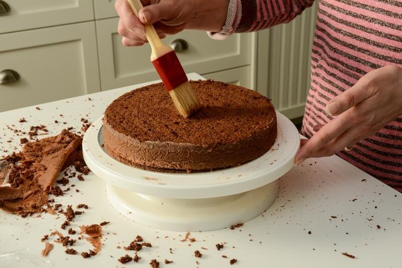 Brushing the crumb off the cake layer.