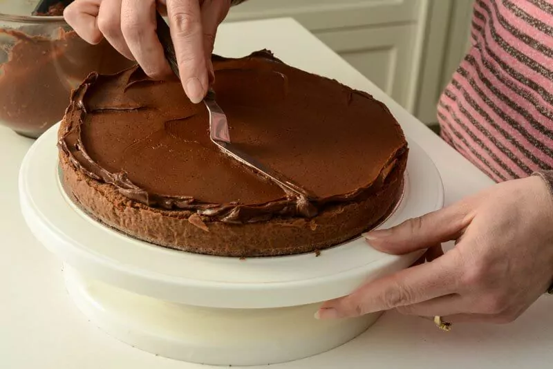 Smoothing on the ganache on the first layer.