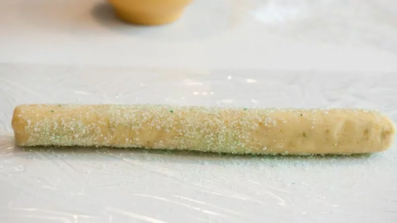 Rolling the dough in sugar.