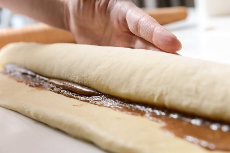 Rolling the dough and the almond filling.
