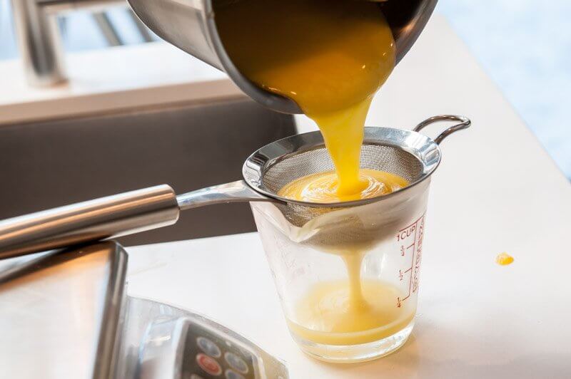 Straining the curd.